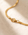Gold lobster claw clasp close-up on snake chain
