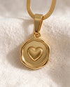 Love Note heart pendant close-up on gold snake chain