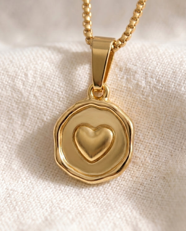 Love Note heart pendant close-up on gold box-link chain