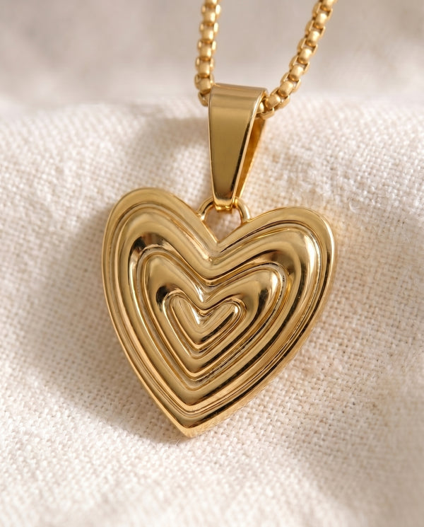 Heart on Your Sleeve pendant close-up on gold box-link chain