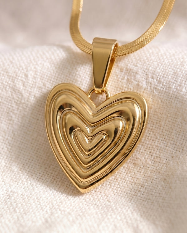 Heart on Your Sleeve pendant close-up on gold snake chain