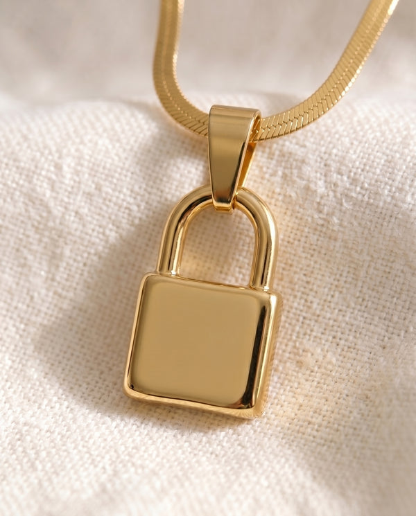 Pinky Promise Lock pendant close-up on gold snake chain