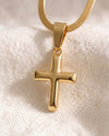 Deep Faith Cross pendant close-up on gold snake chain