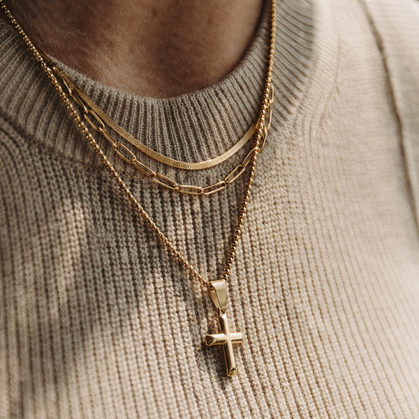 The Faith Stack — layered gold necklaces and pendant on a model